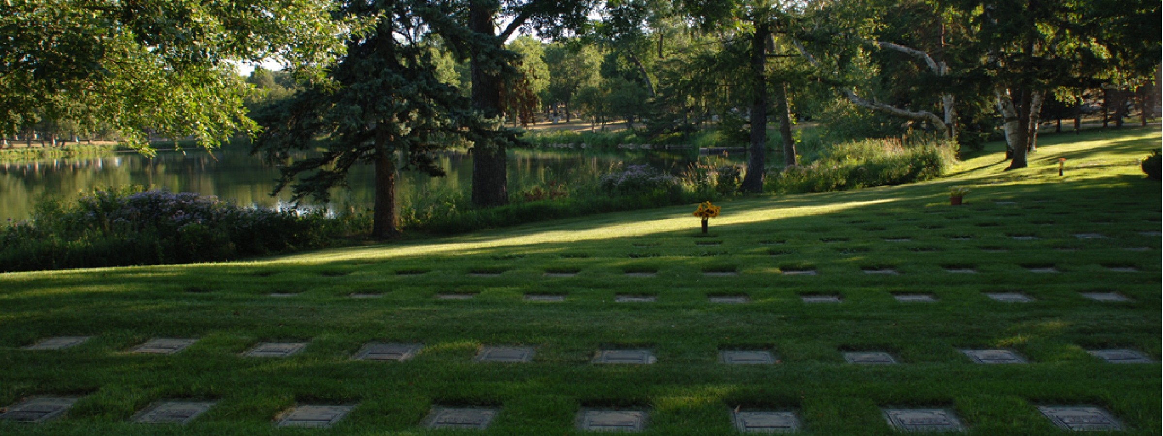 View of a grassy cemetary with ground markers