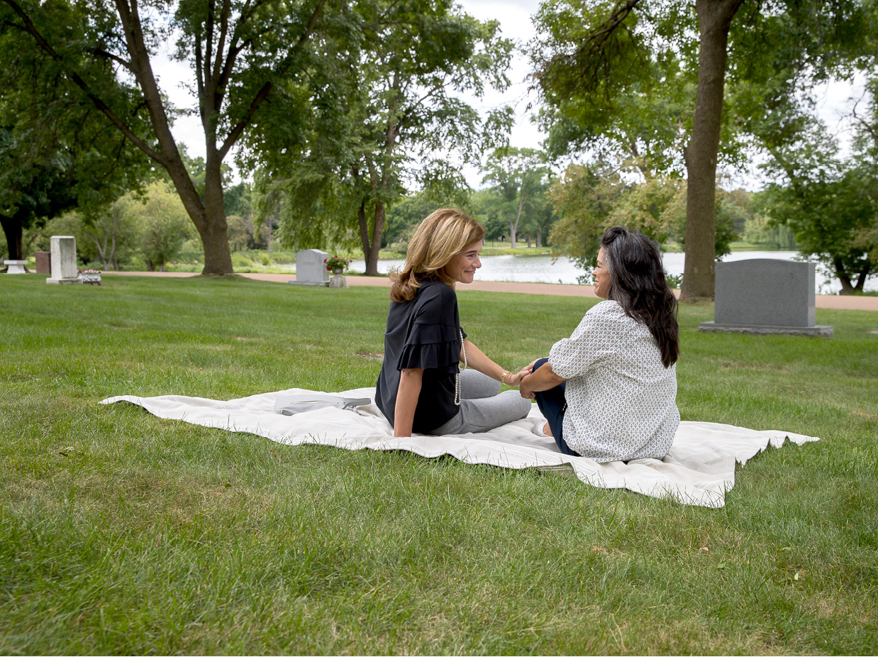 Two women talking on a blanket at Lakewood